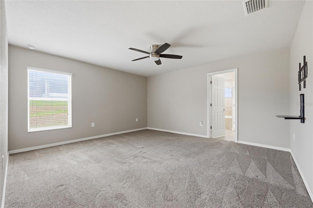 306 Stone Point Lane Lady Lake, FL 32159 - Photo 22 of 39 an empty room with a window and a ceiling fan