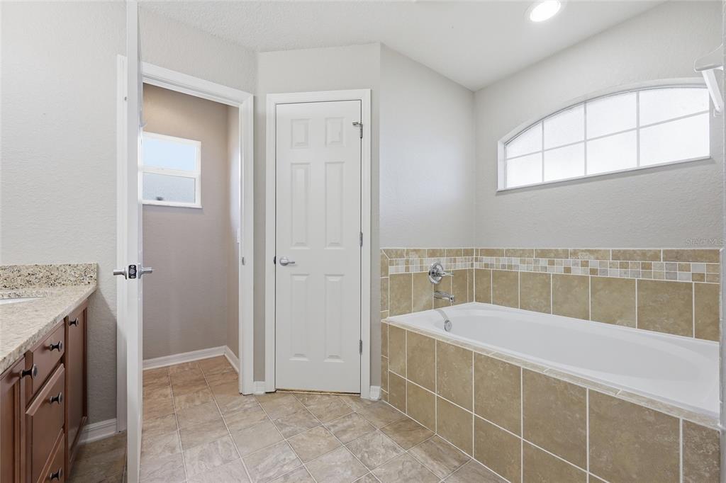 306 Stone Point Lane Lady Lake, FL 32159 - Photo 25 of 39 a spacious bathroom with a tub and a shower