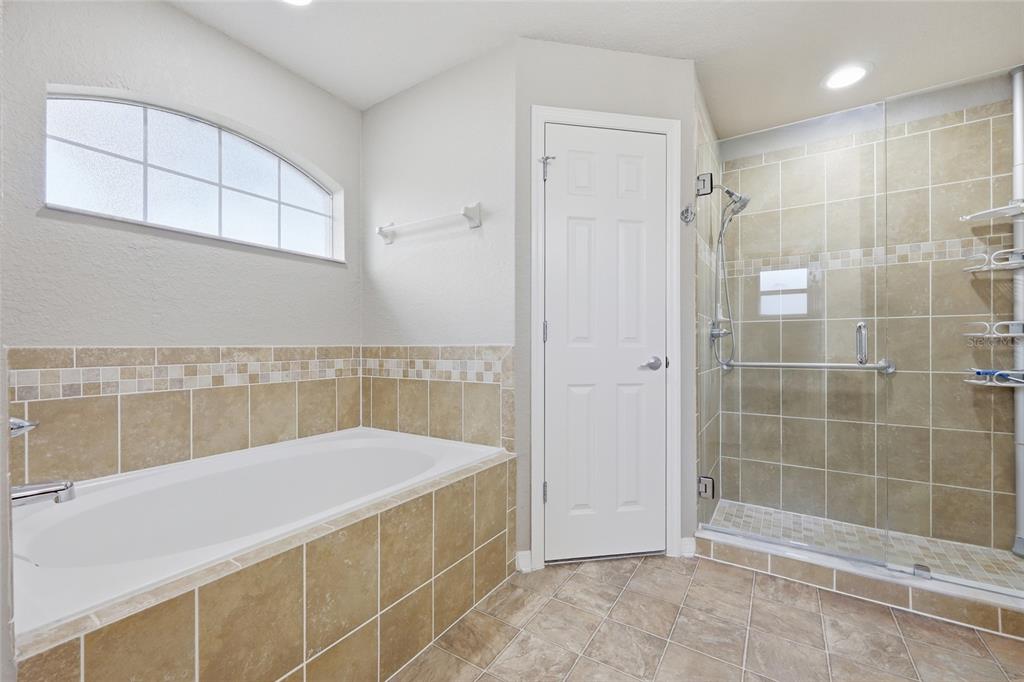 306 Stone Point Lane Lady Lake, FL 32159 - Photo 26 of 39 a bathroom with a bathtub and shower