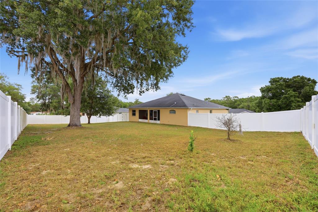 306 Stone Point Lane Lady Lake, FL 32159 - Photo 32 of 39 a blue swimming pool is in front of a house
