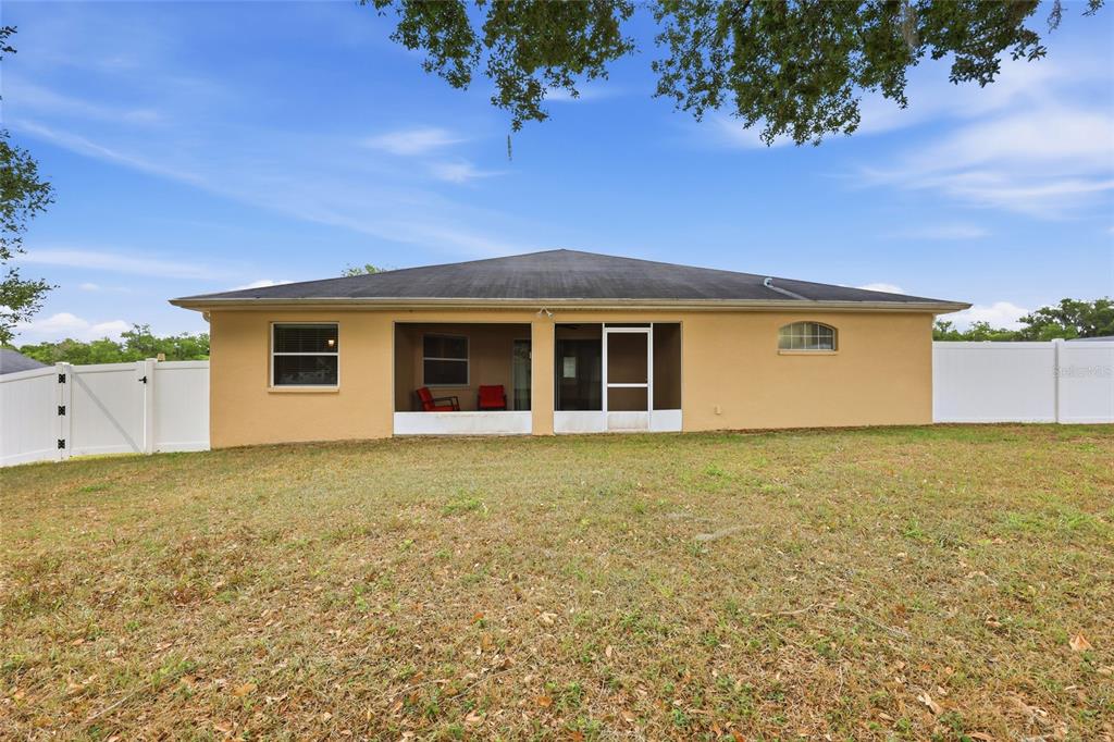 306 Stone Point Lane Lady Lake, FL 32159 - Photo 34 of 39 a view of an house with backyard space and garden