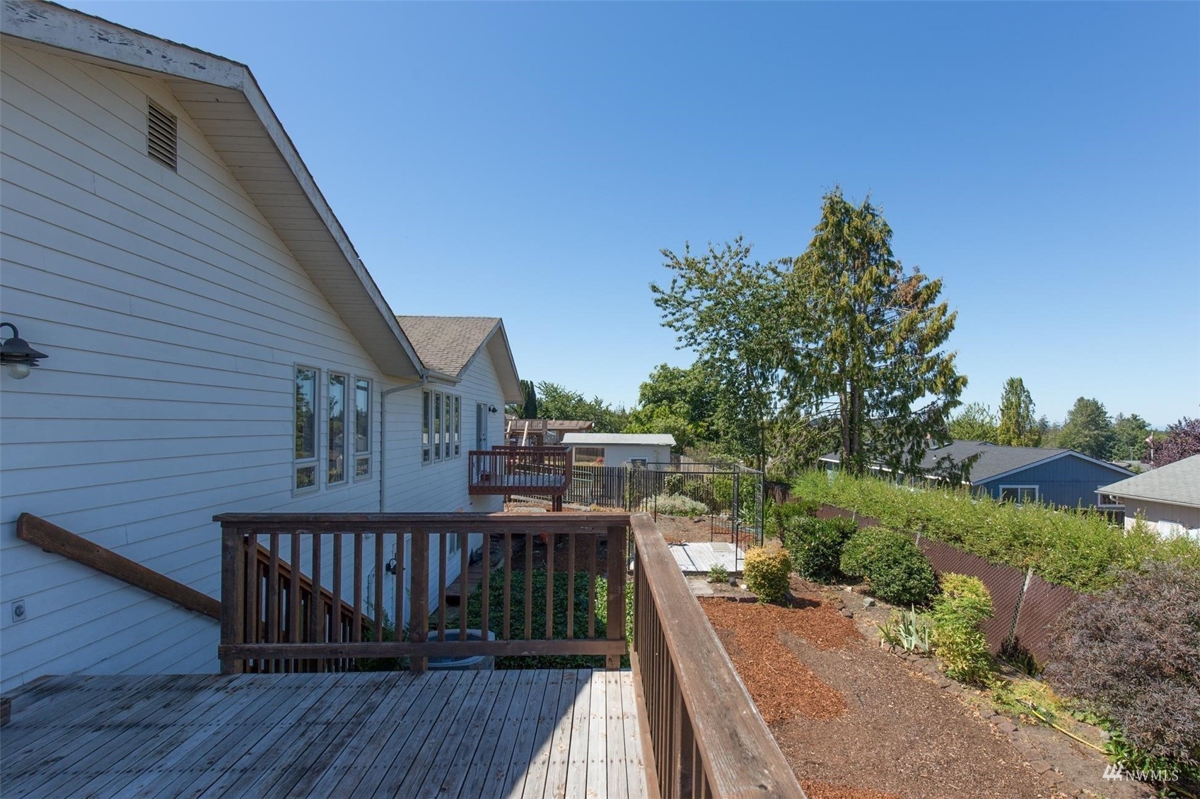 308 Eunice Street Sequim, WA 98382 - Photo 15 of 38 a view of a balcony with wooden floor and fence