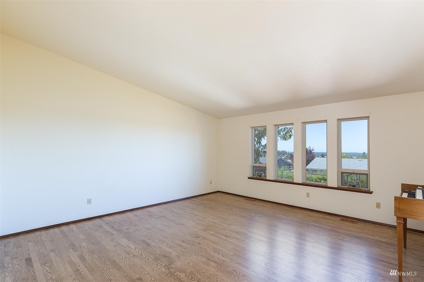 308 Eunice Street Sequim, WA 98382 - Photo 20 of 38 an empty room with wooden floor and windows