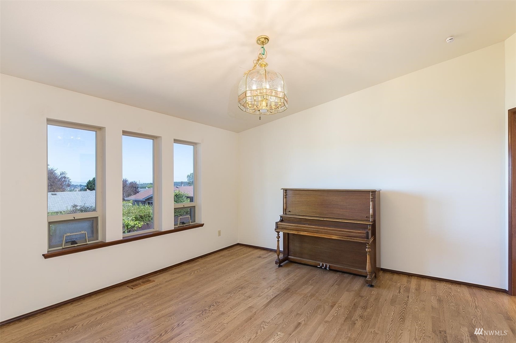 308 Eunice Street Sequim, WA 98382 - Photo 21 of 38 a view of an empty room with wooden floor and a window