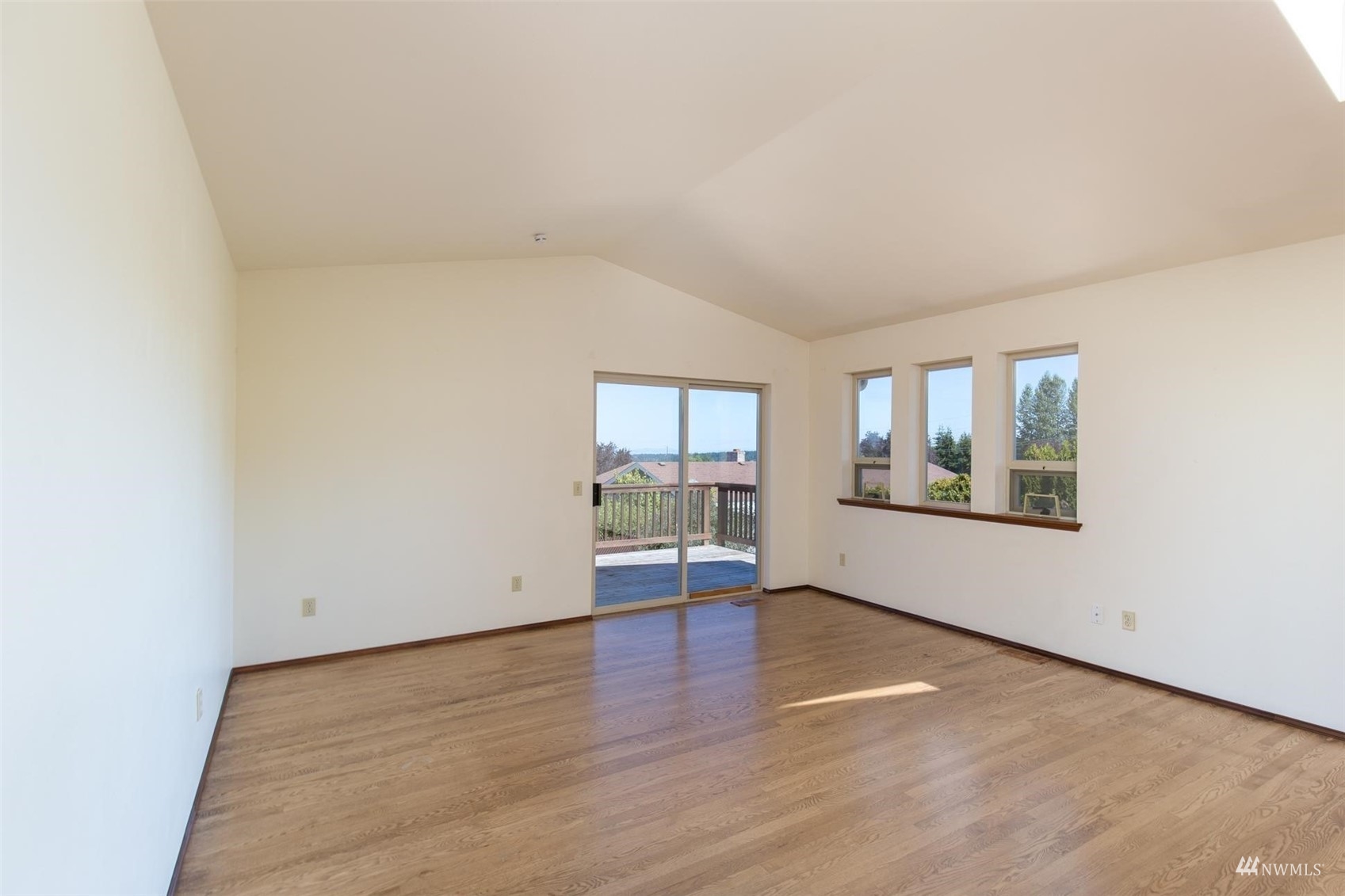 308 Eunice Street Sequim, WA 98382 - Photo 26 of 38 an empty room with wooden floor and windows