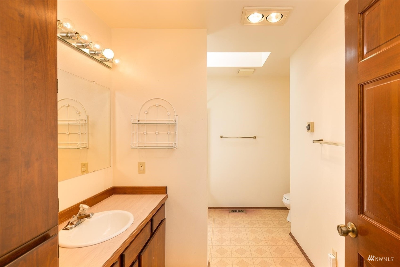 308 Eunice Street Sequim, WA 98382 - Photo 32 of 38 a bathroom with a granite countertop sink a mirror and a shower