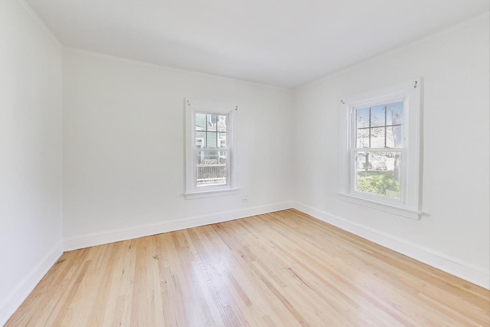 421 East Indiana Street Wheaton, IL 60187 - Photo 11 of 37 an empty room with wooden floor and windows