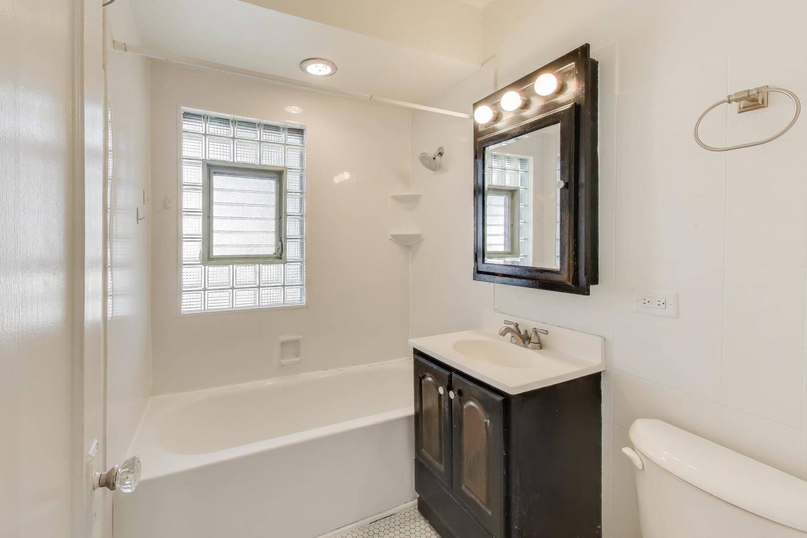 421 East Indiana Street Wheaton, IL 60187 - Photo 14 of 37 a bathroom with a tub sink toilet and mirror