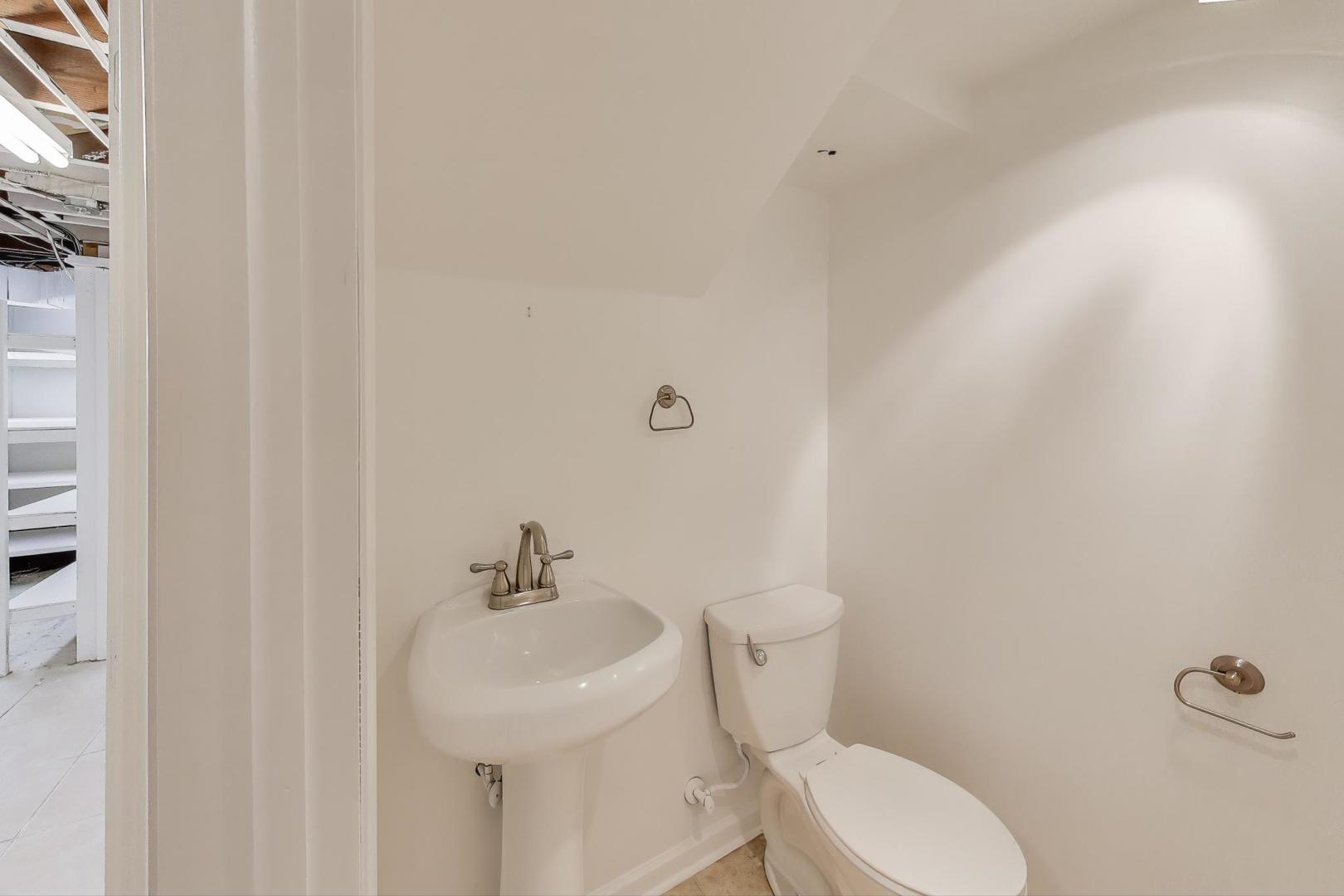 421 East Indiana Street Wheaton, IL 60187 - Photo 20 of 37 a white toilet sitting next to a bathroom sink