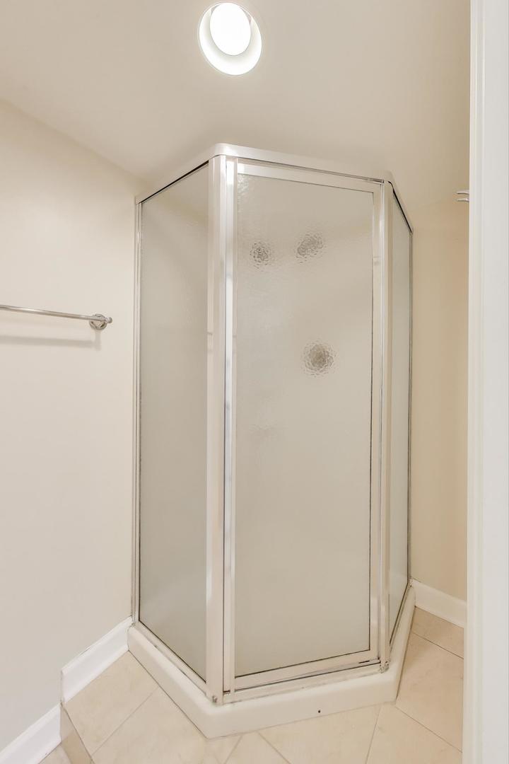 421 East Indiana Street Wheaton, IL 60187 - Photo 21 of 37 a bathroom with a glass shower door