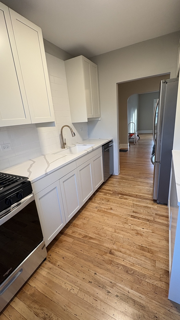 421 East Indiana Street Wheaton, IL 60187 - Photo 33 of 37 a large kitchen with a stove and a sink
