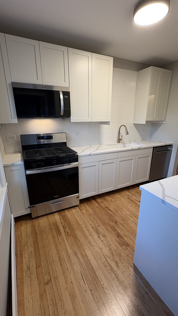 421 East Indiana Street Wheaton, IL 60187 - Photo 34 of 37 a kitchen with sink and cabinets