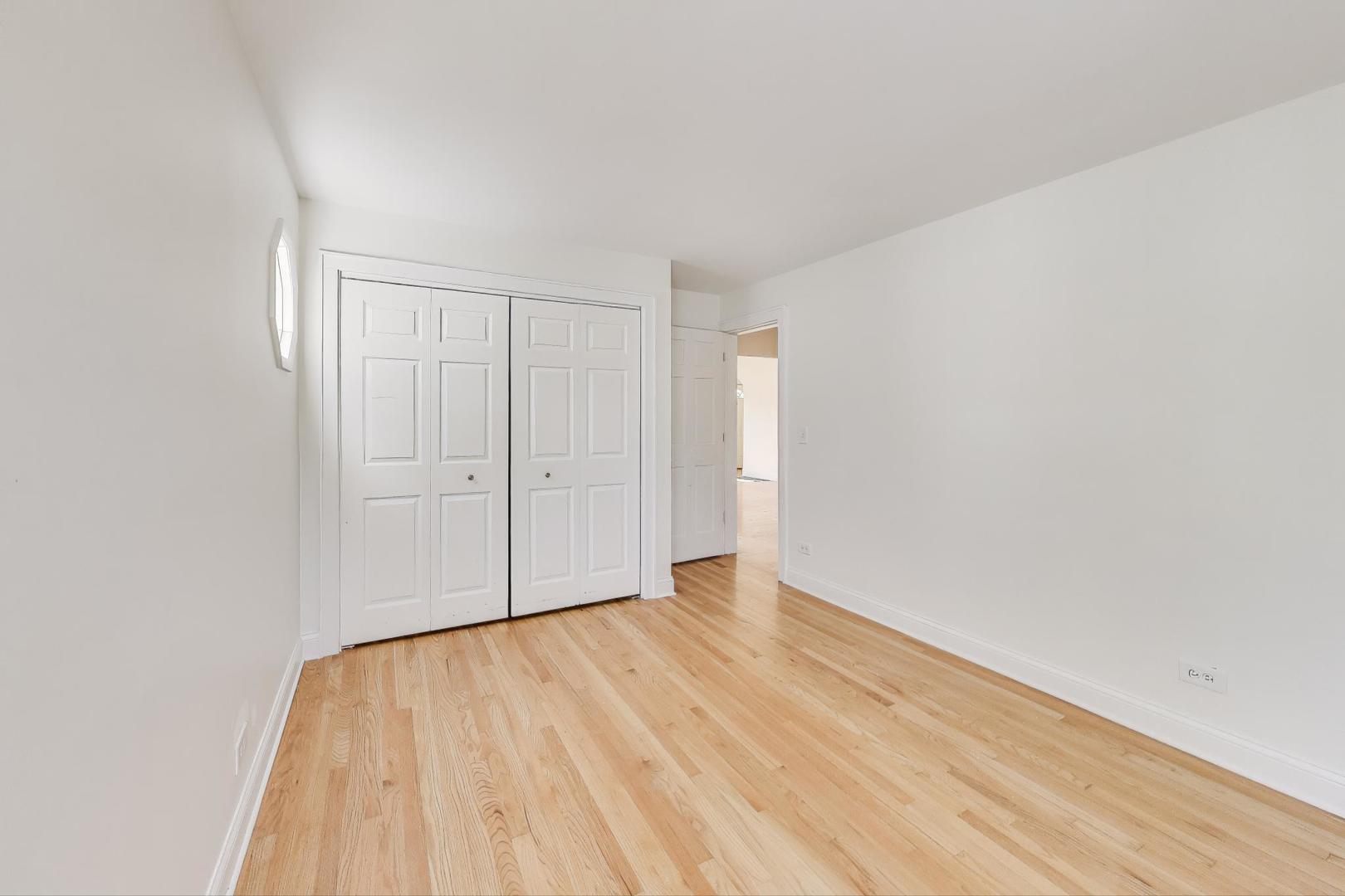 421 East Indiana Street Wheaton, IL 60187 - Photo 8 of 37 a view of an empty room with wooden floor