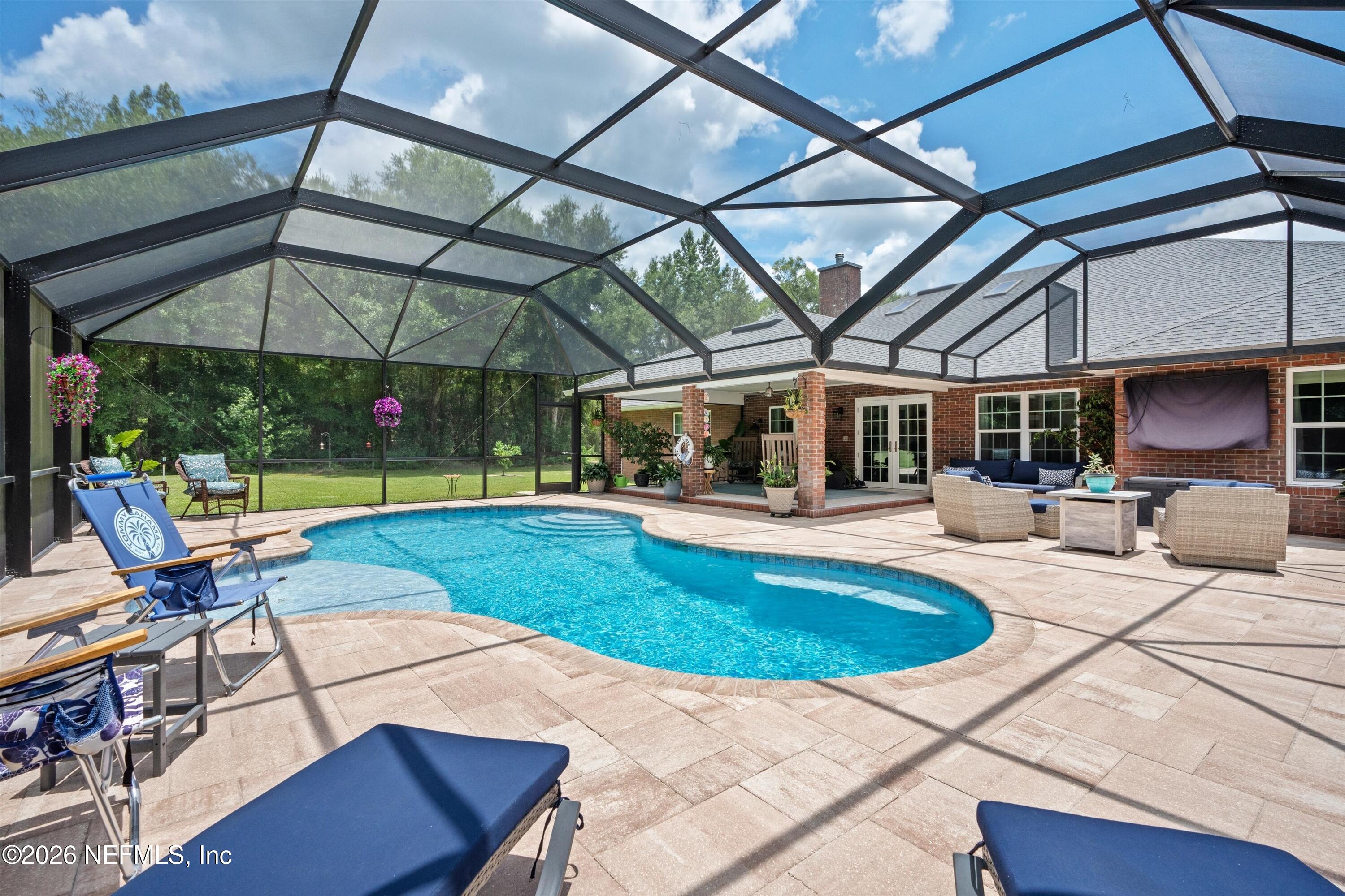 5566 Don Manuel Road Elkton, FL 32033 - Photo 38 of 47 a view of a patio with a table and chairs under an umbrella