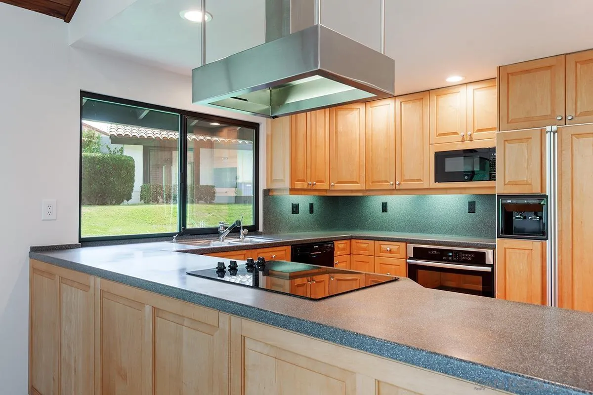 1332 Sun Valley Road Solana Beach, CA 92075 - Photo 11 of 38 a kitchen with stainless steel appliances granite countertop a sink and a microwave