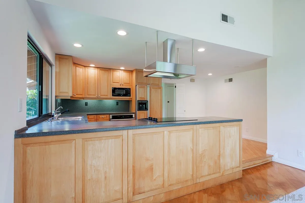 1332 Sun Valley Road Solana Beach, CA 92075 - Photo 14 of 38 a kitchen with stainless steel appliances kitchen island granite countertop a sink and a cabinets