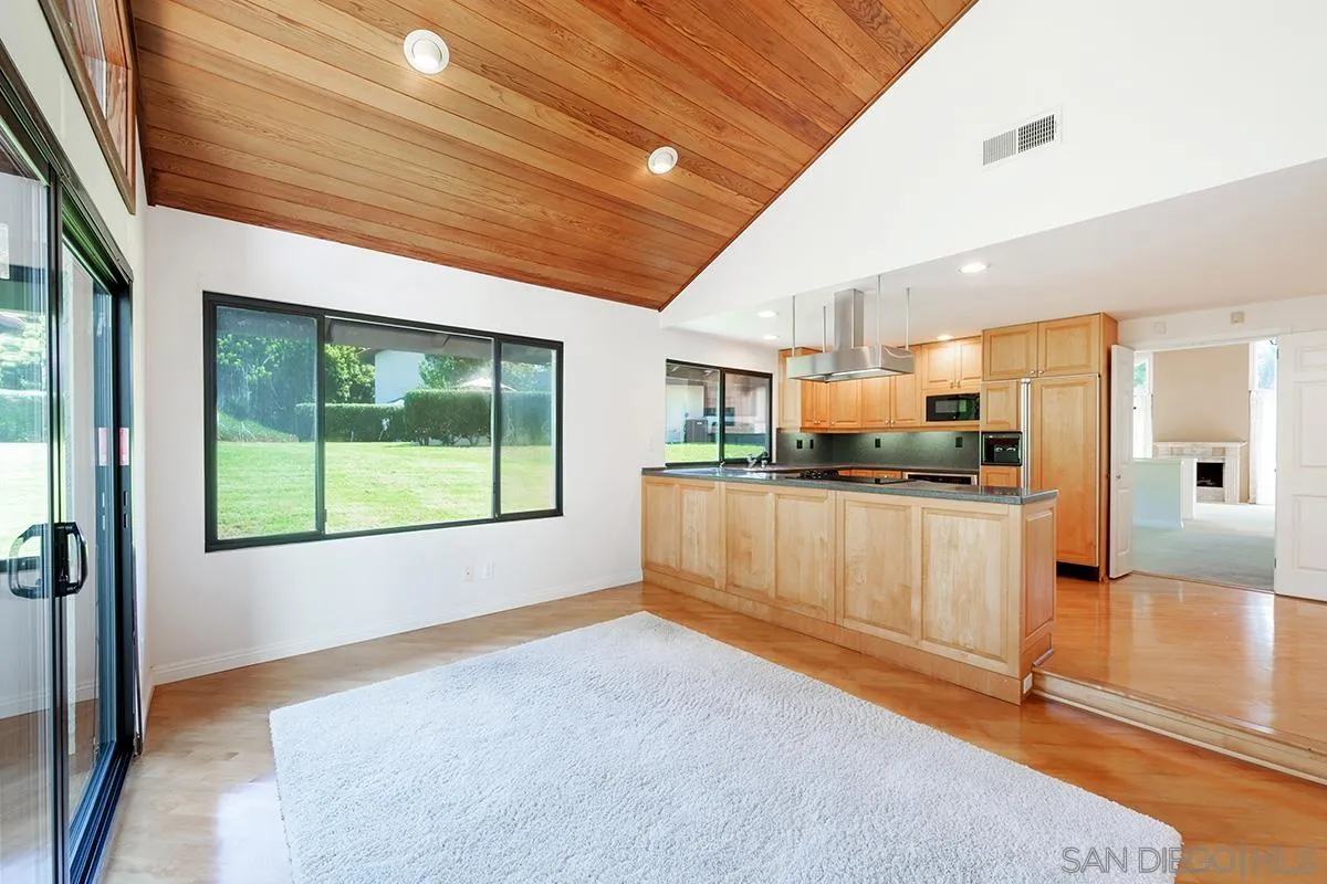 1332 Sun Valley Road Solana Beach, CA 92075 - Photo 15 of 38 a kitchen with stainless steel appliances kitchen island granite countertop a refrigerator and a stove