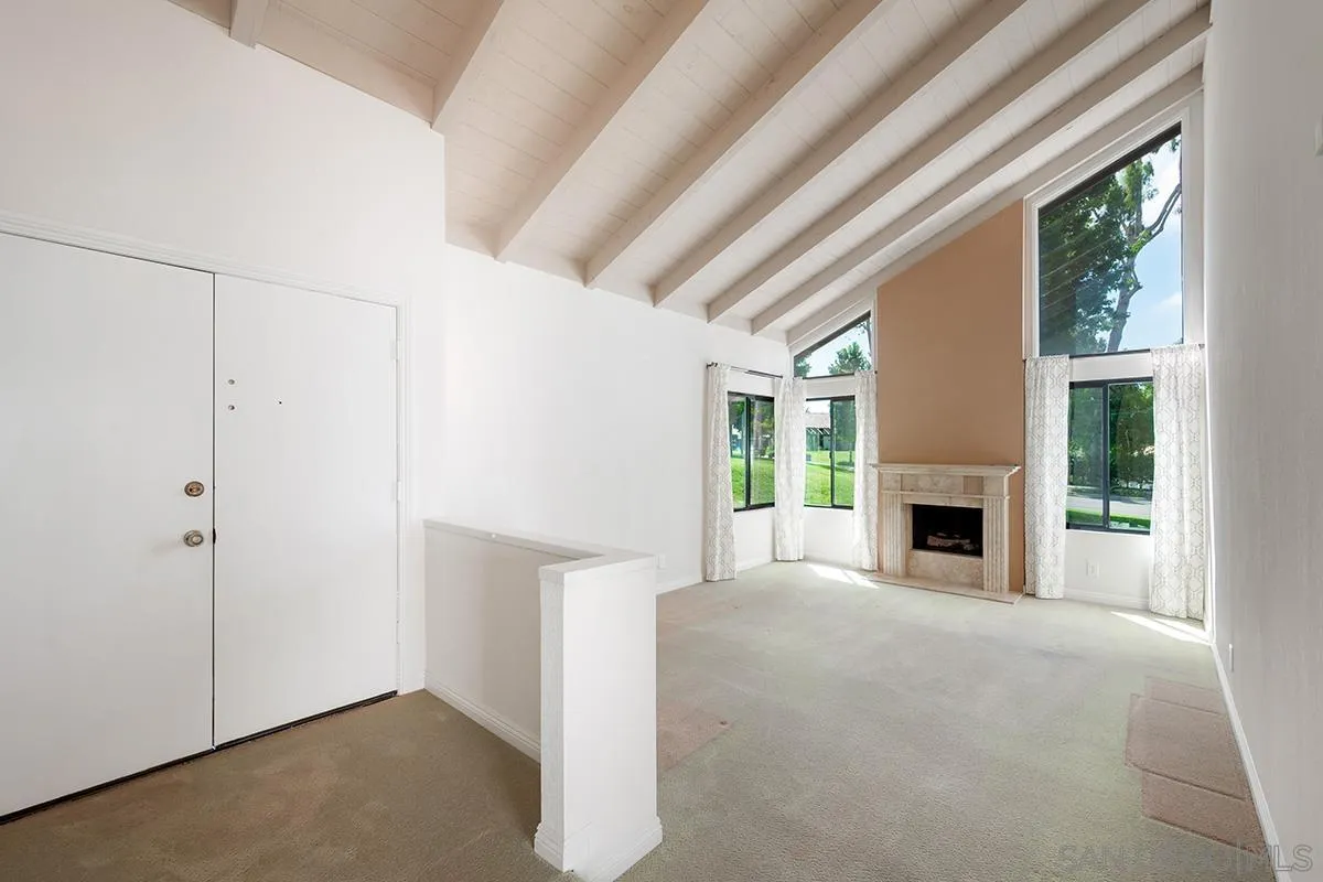 1332 Sun Valley Road Solana Beach, CA 92075 - Photo 5 of 38 a view of an empty room with a fireplace and a window