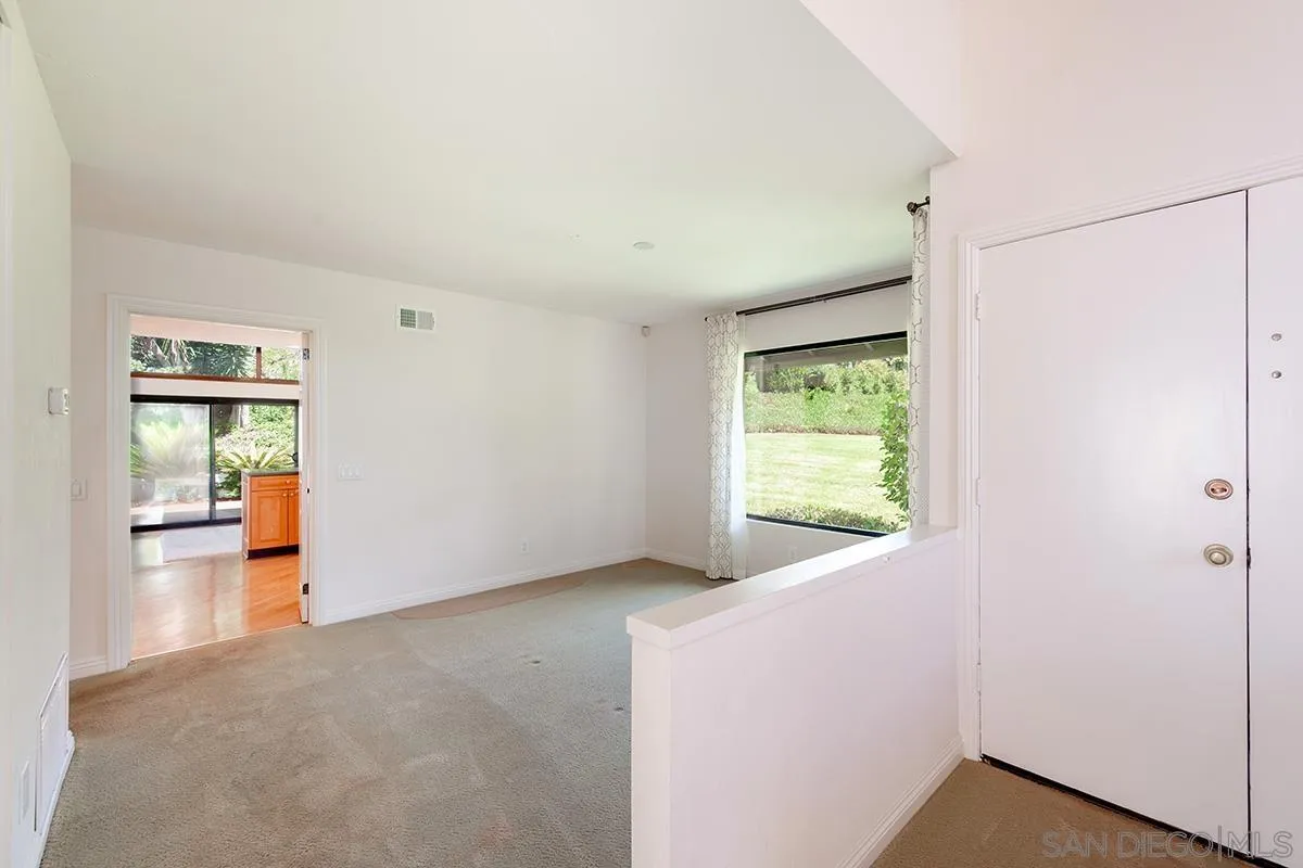 1332 Sun Valley Road Solana Beach, CA 92075 - Photo 9 of 38 a view of an empty room with window and wooden floor