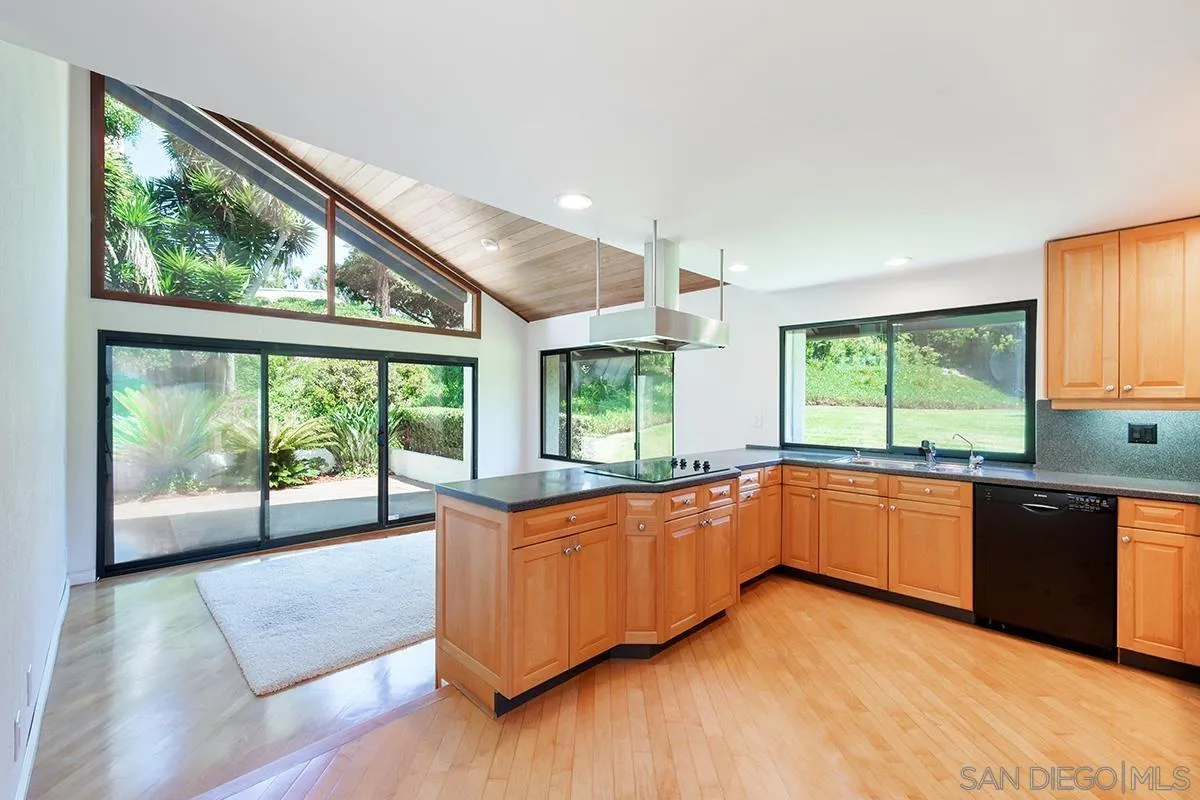 1332 Sun Valley Road Solana Beach, CA 92075 - Photo 10 of 38 a large kitchen with kitchen island a large window a sink and appliances