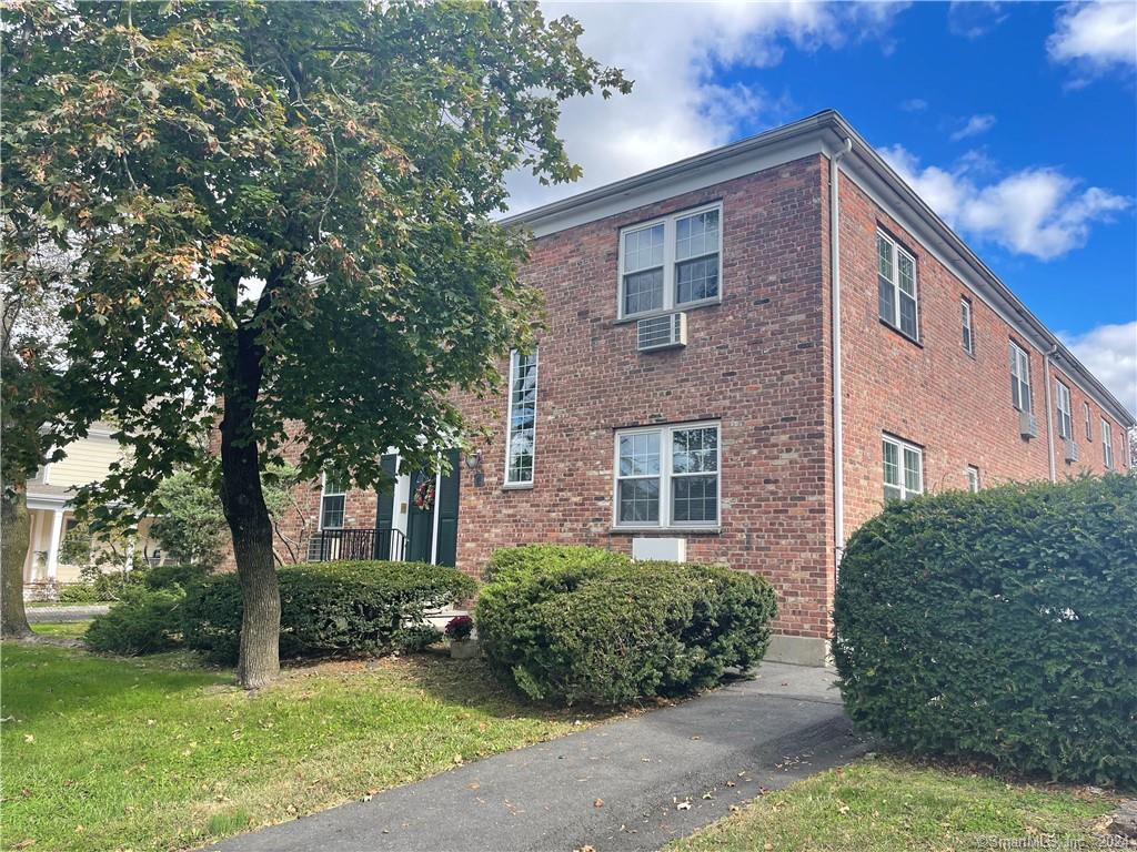 11 Belltown Road, Unit 7 Stamford, CT 06905 - Photo 1 of 1 a front view of a house with garden