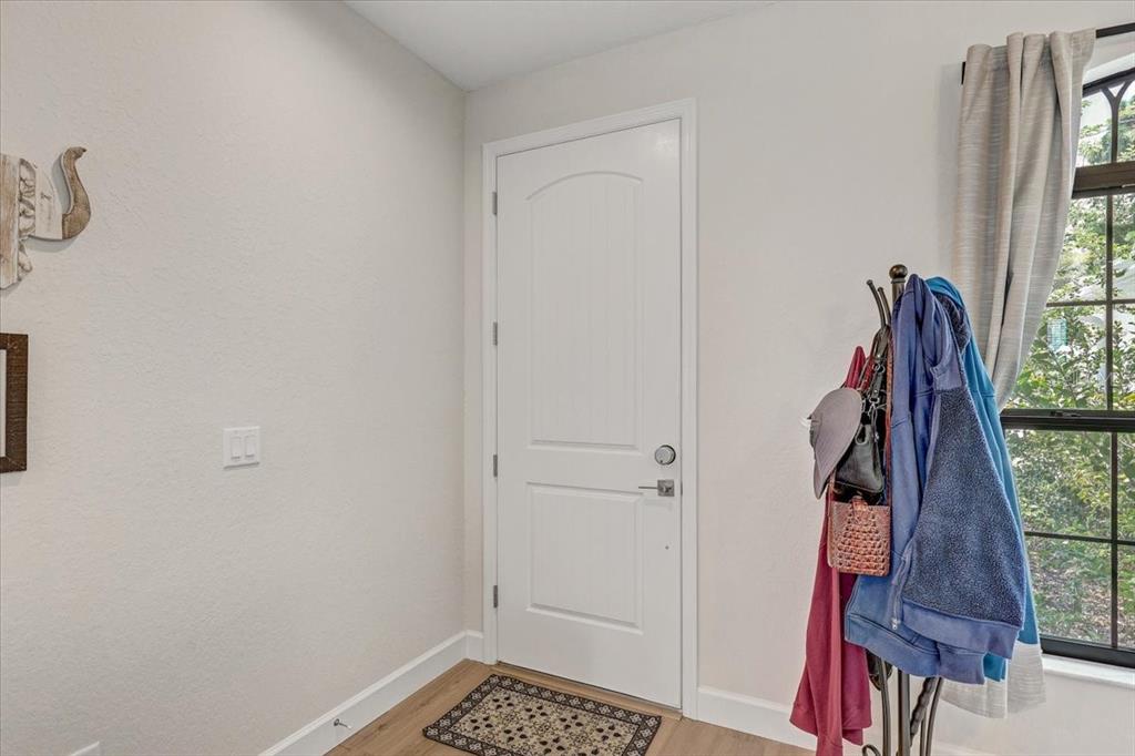 7314 Madrid Road Weeki Wachee, FL 34613 - Photo 4 of 54 a view of walk in closet with clothes and shoes