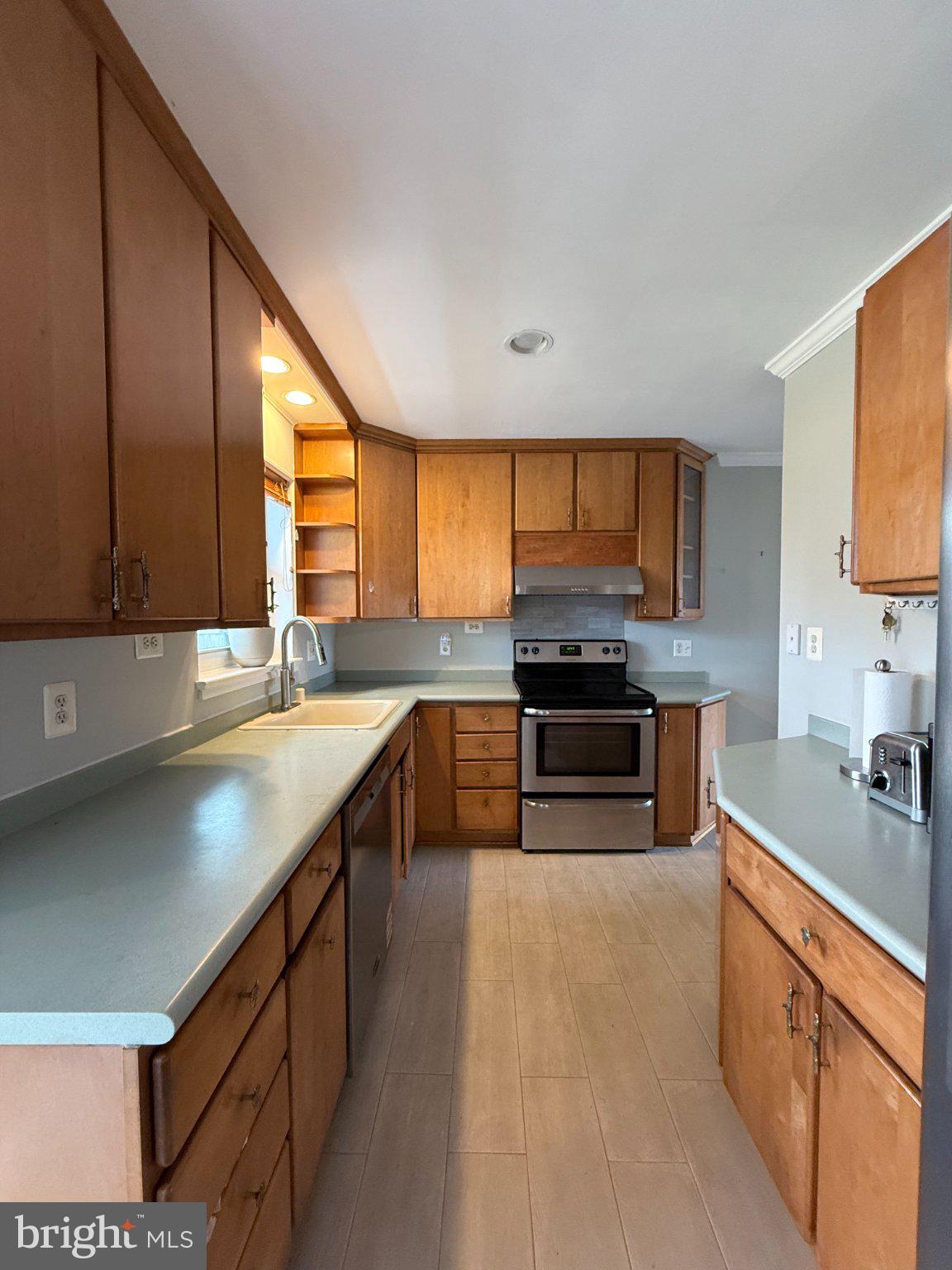 9709 Saxony Road Silver Spring, MD 20910 - Photo 11 of 47 a kitchen with stainless steel appliances granite countertop a sink and a stove