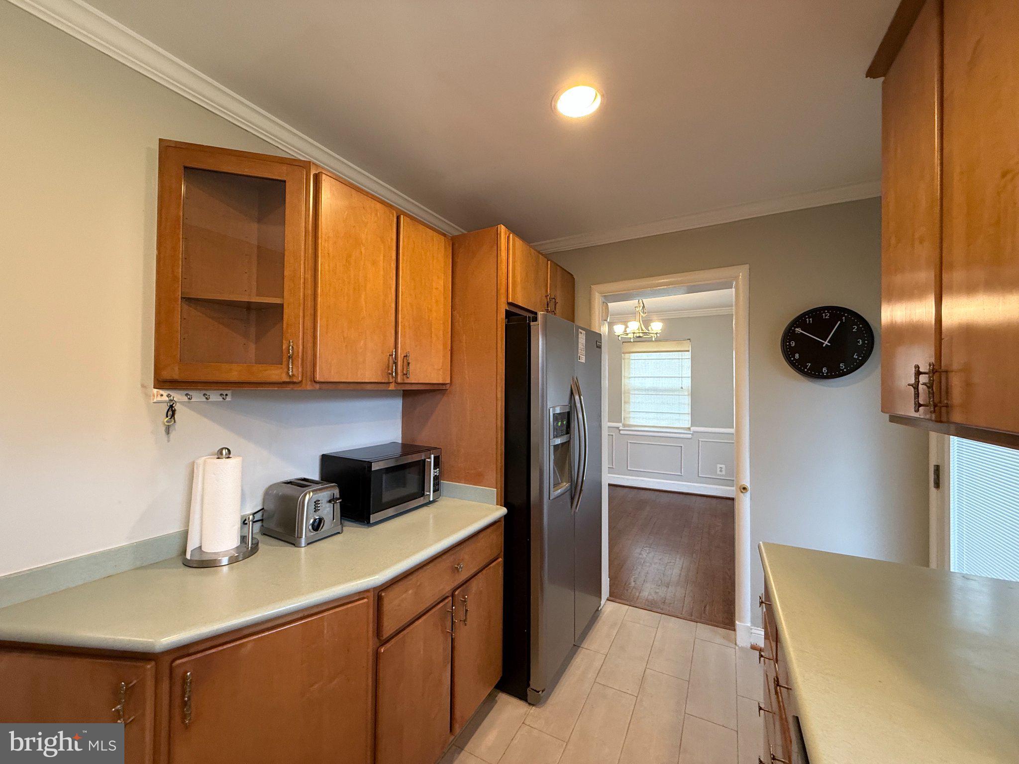9709 Saxony Road Silver Spring, MD 20910 - Photo 14 of 47 a kitchen with a refrigerator and a sink