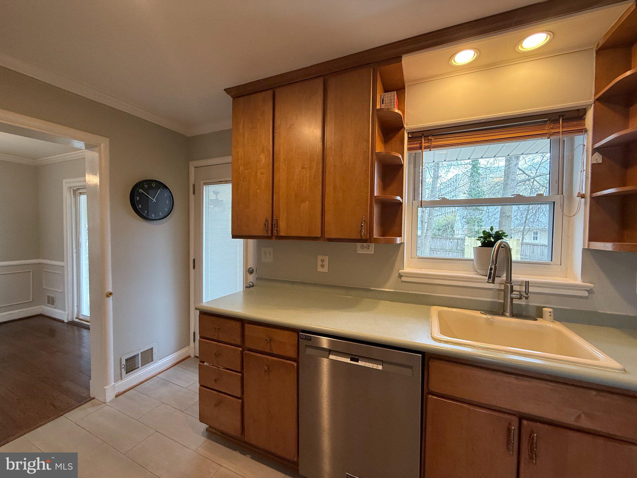 9709 Saxony Road Silver Spring, MD 20910 - Photo 15 of 47 a kitchen with a sink and a refrigerator