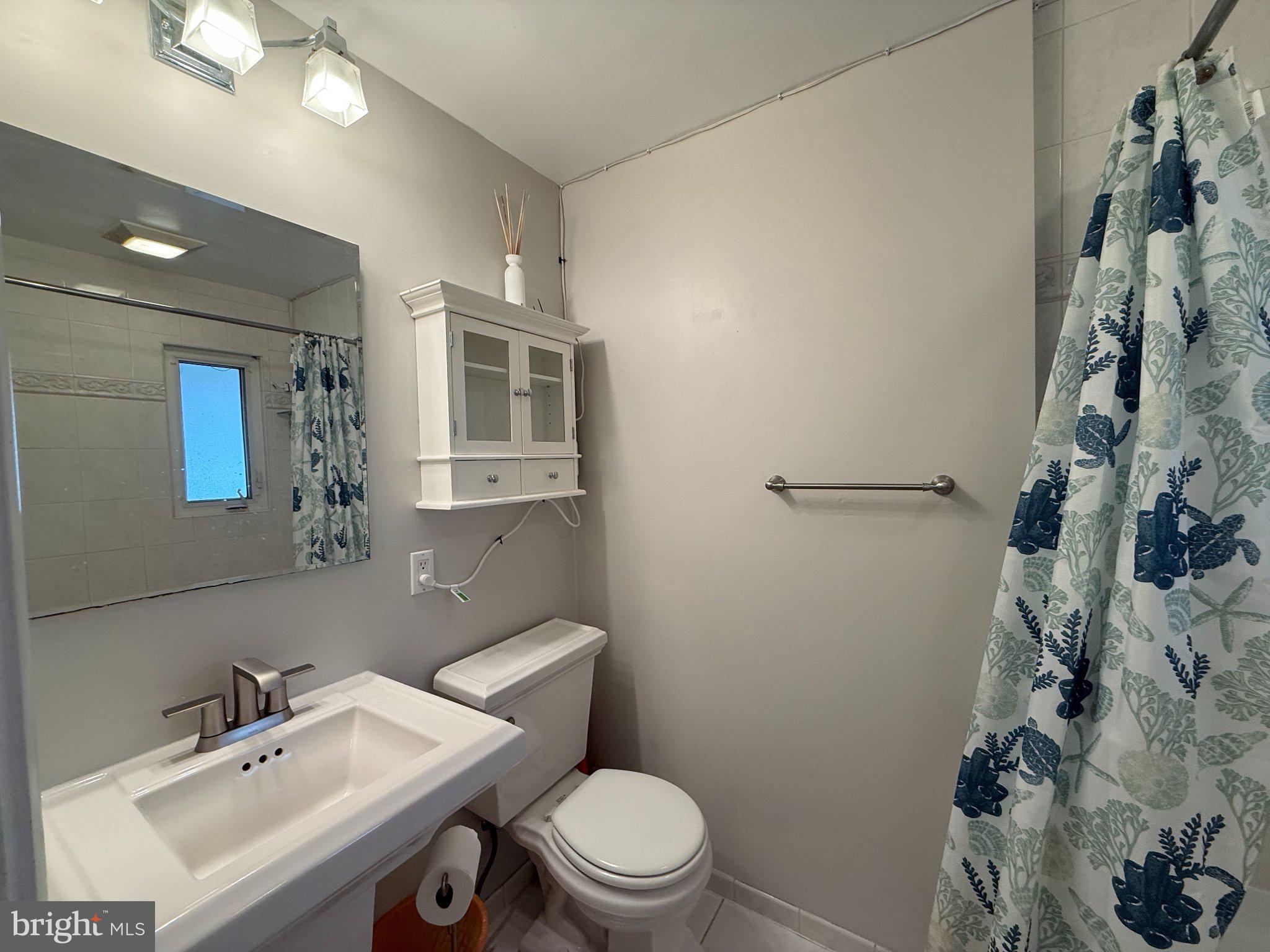 9709 Saxony Road Silver Spring, MD 20910 - Photo 18 of 47 a bathroom with a sink mirror and toilet