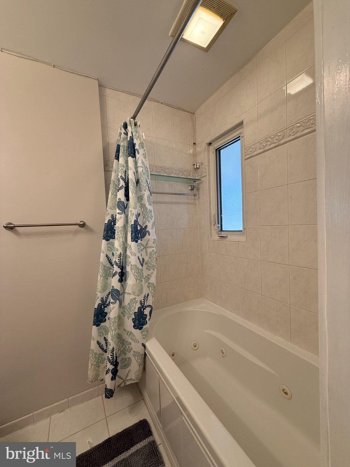 9709 Saxony Road Silver Spring, MD 20910 - Photo 19 of 47 a bathroom with a bathtub a shower and a sink