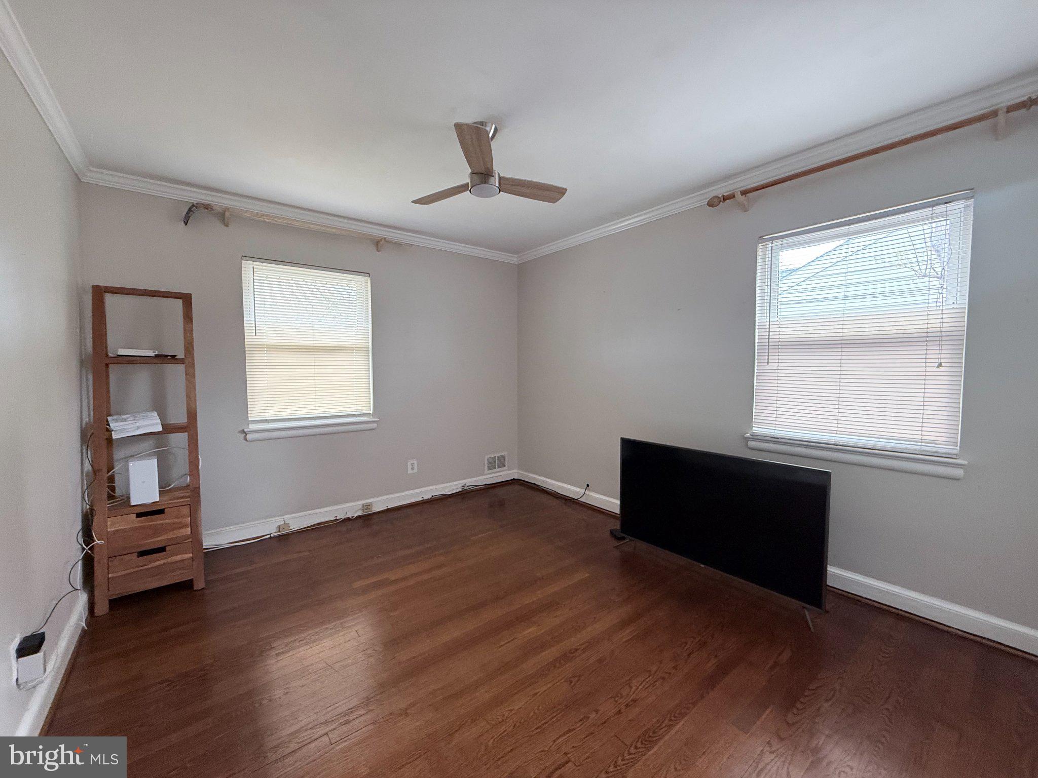 9709 Saxony Road Silver Spring, MD 20910 - Photo 27 of 47 a view of an empty room with wooden floor and a window