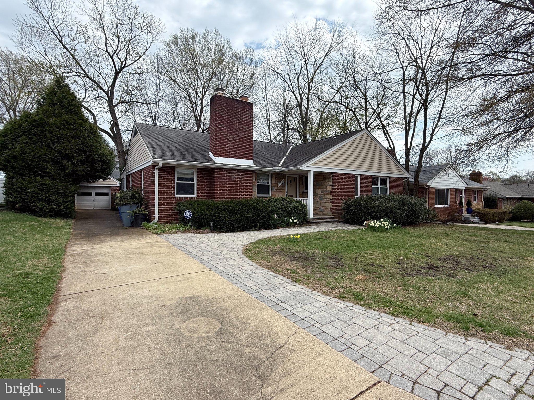 9709 Saxony Road Silver Spring, MD 20910 - Photo 4 of 47 a front view of a house with a yard and trees