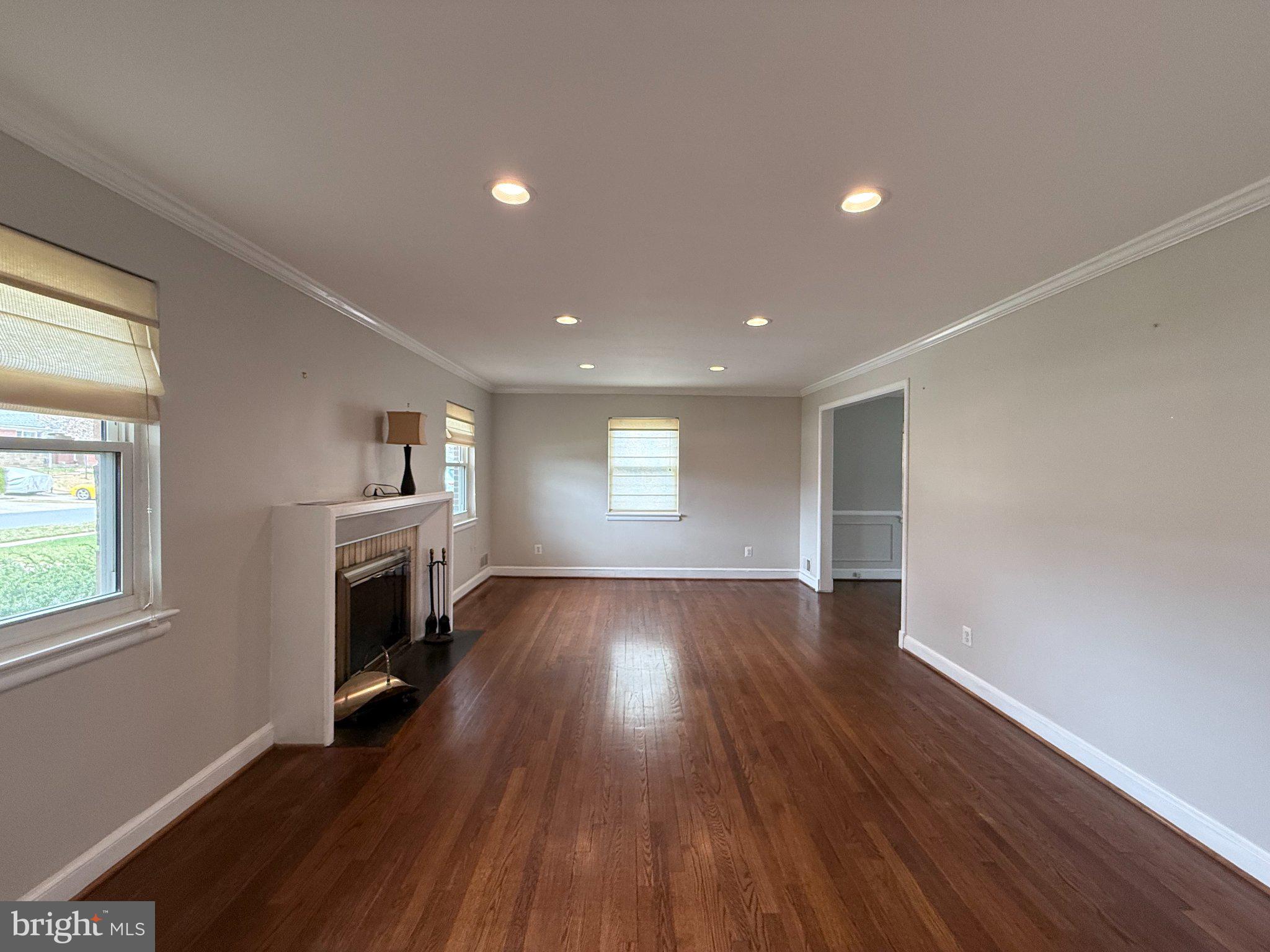 9709 Saxony Road Silver Spring, MD 20910 - Photo 7 of 47 a view of empty room with fireplace and wooden floor