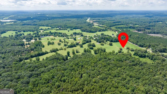 an aerial view of a house with a yard