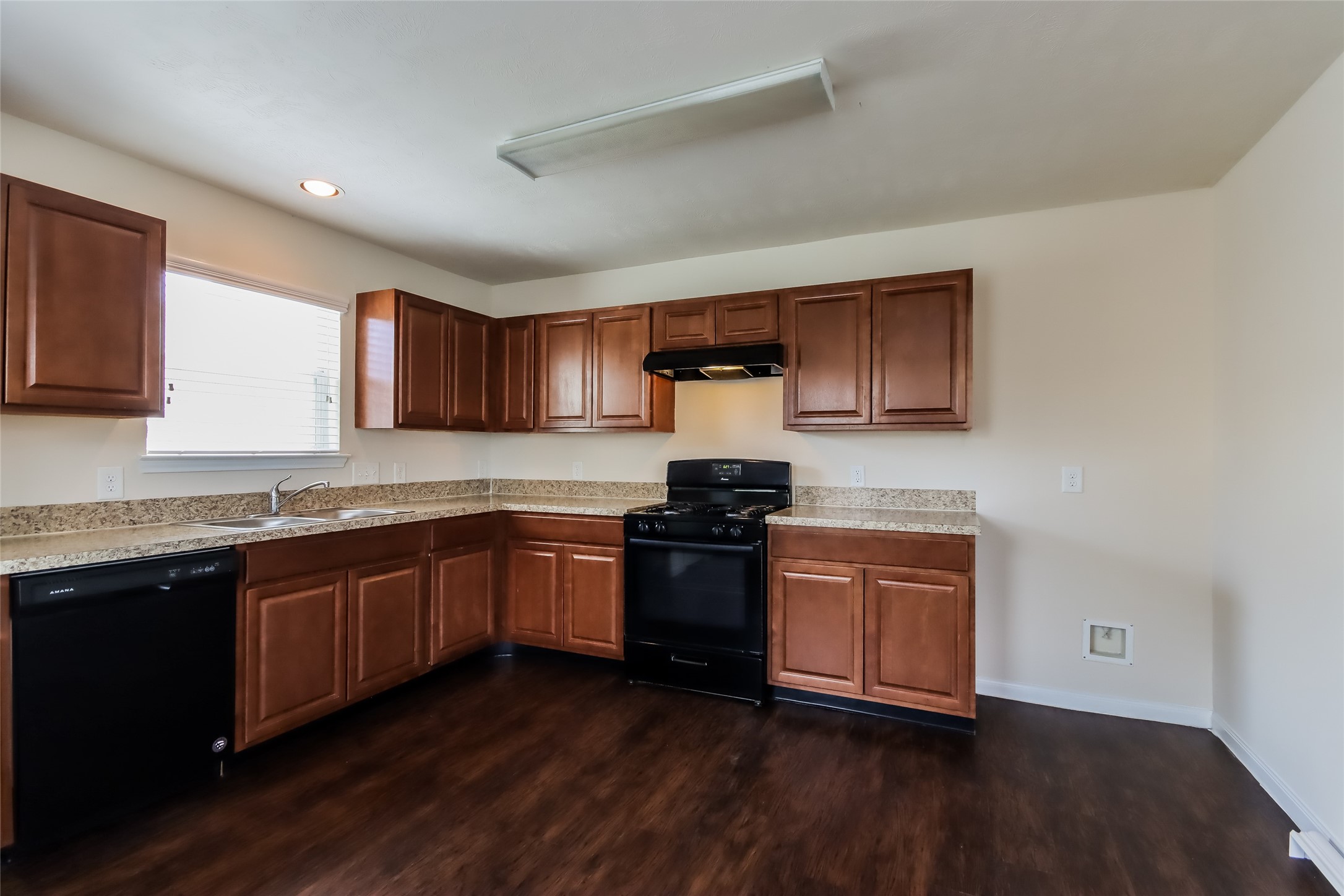 2411 High Island Way Houston, TX 77073 - Photo 3 of 13 a kitchen with granite countertop wooden cabinets and a stove top oven