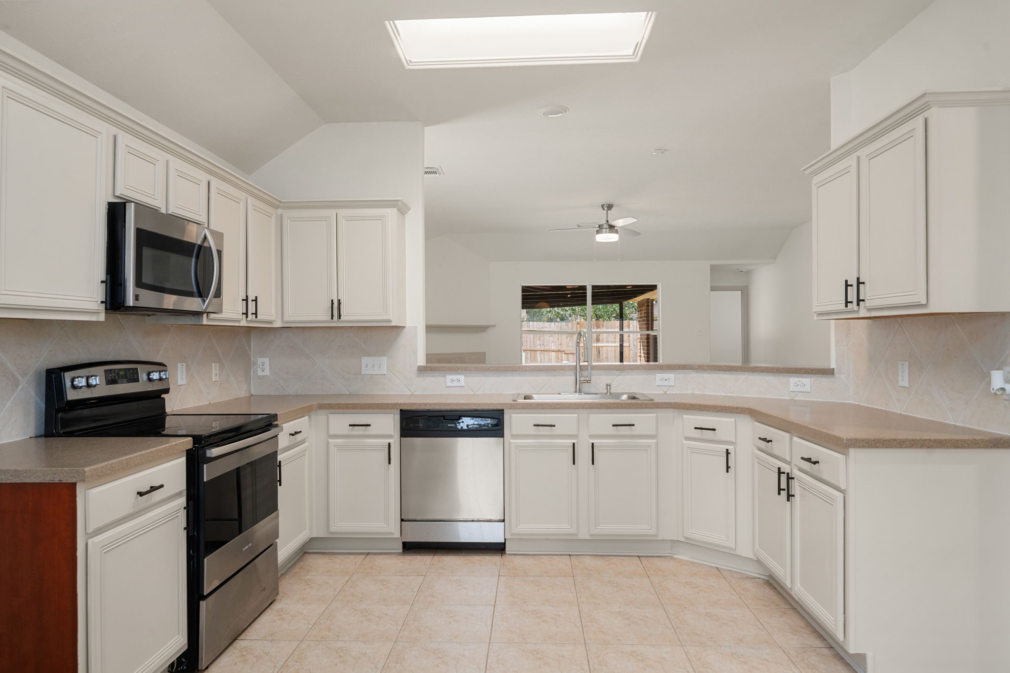 13410 Baron Hill Lane Rosharon, TX 77583 - Photo 11 of 40 a kitchen with granite countertop white cabinets and white appliances