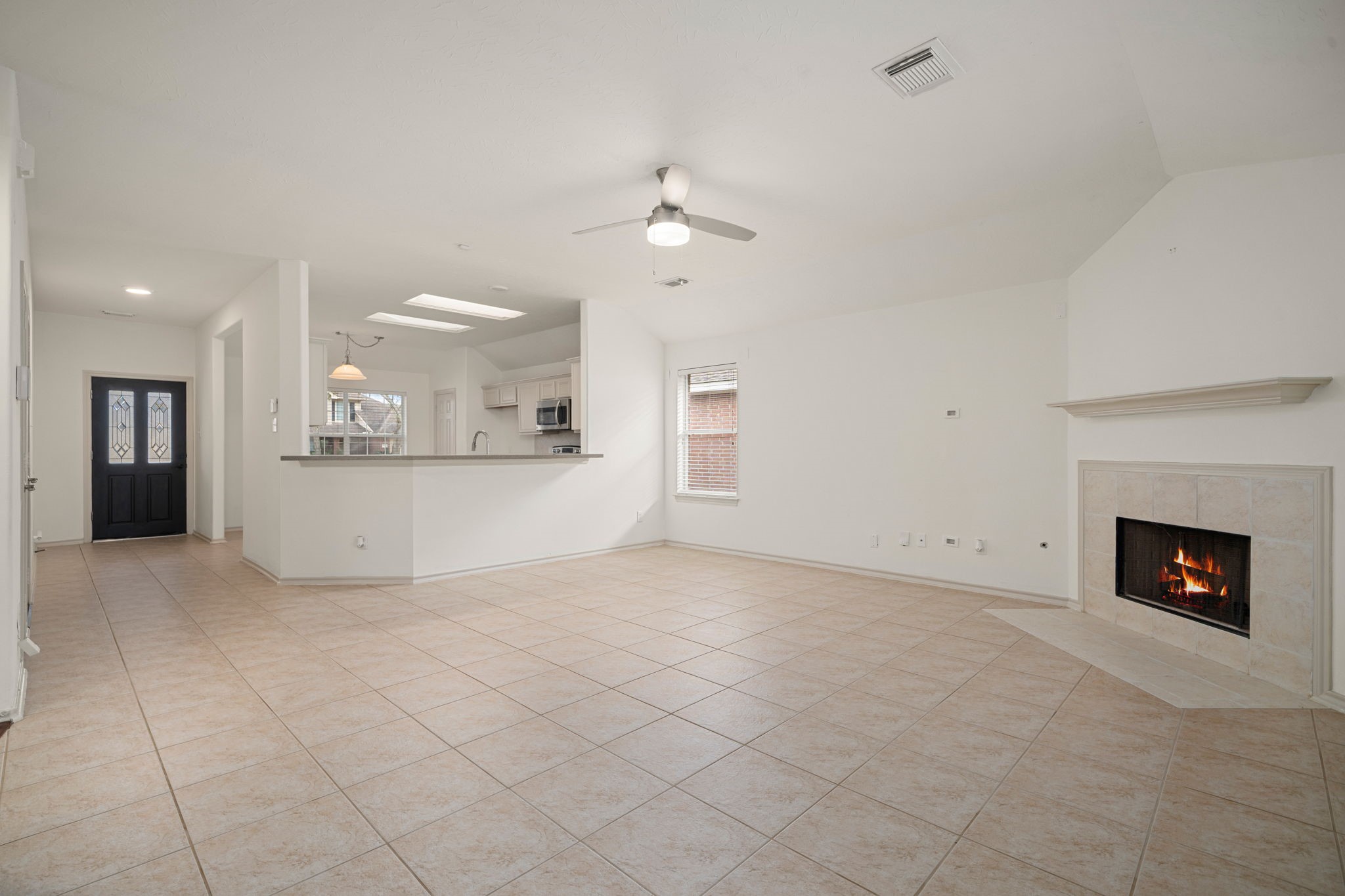 13410 Baron Hill Lane Rosharon, TX 77583 - Photo 17 of 40 an empty room with kitchen view and a fireplace