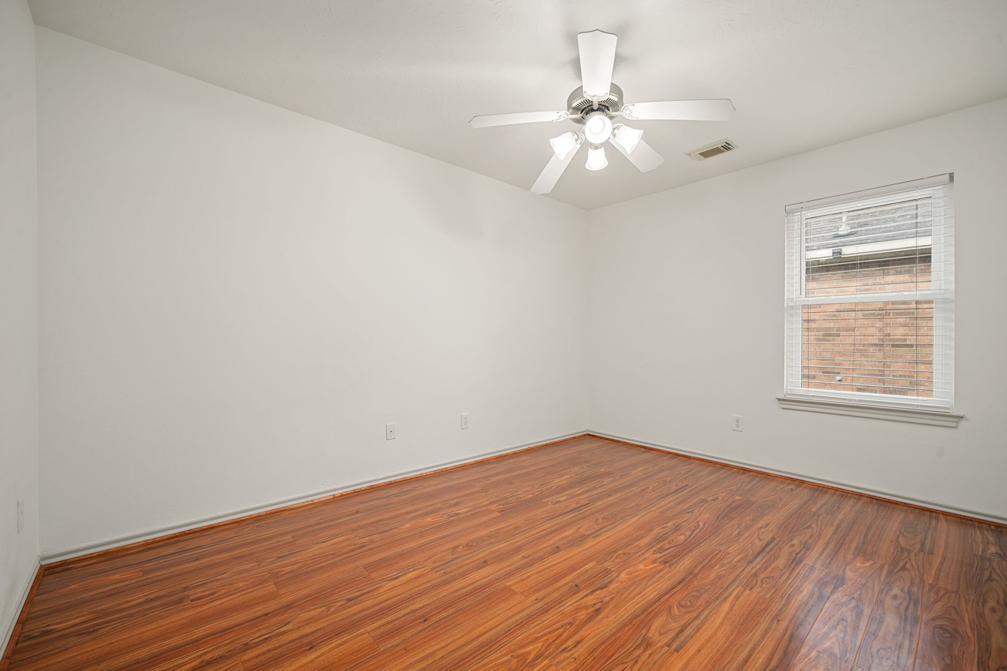 13410 Baron Hill Lane Rosharon, TX 77583 - Photo 28 of 40 wooden floor in an empty room with a window
