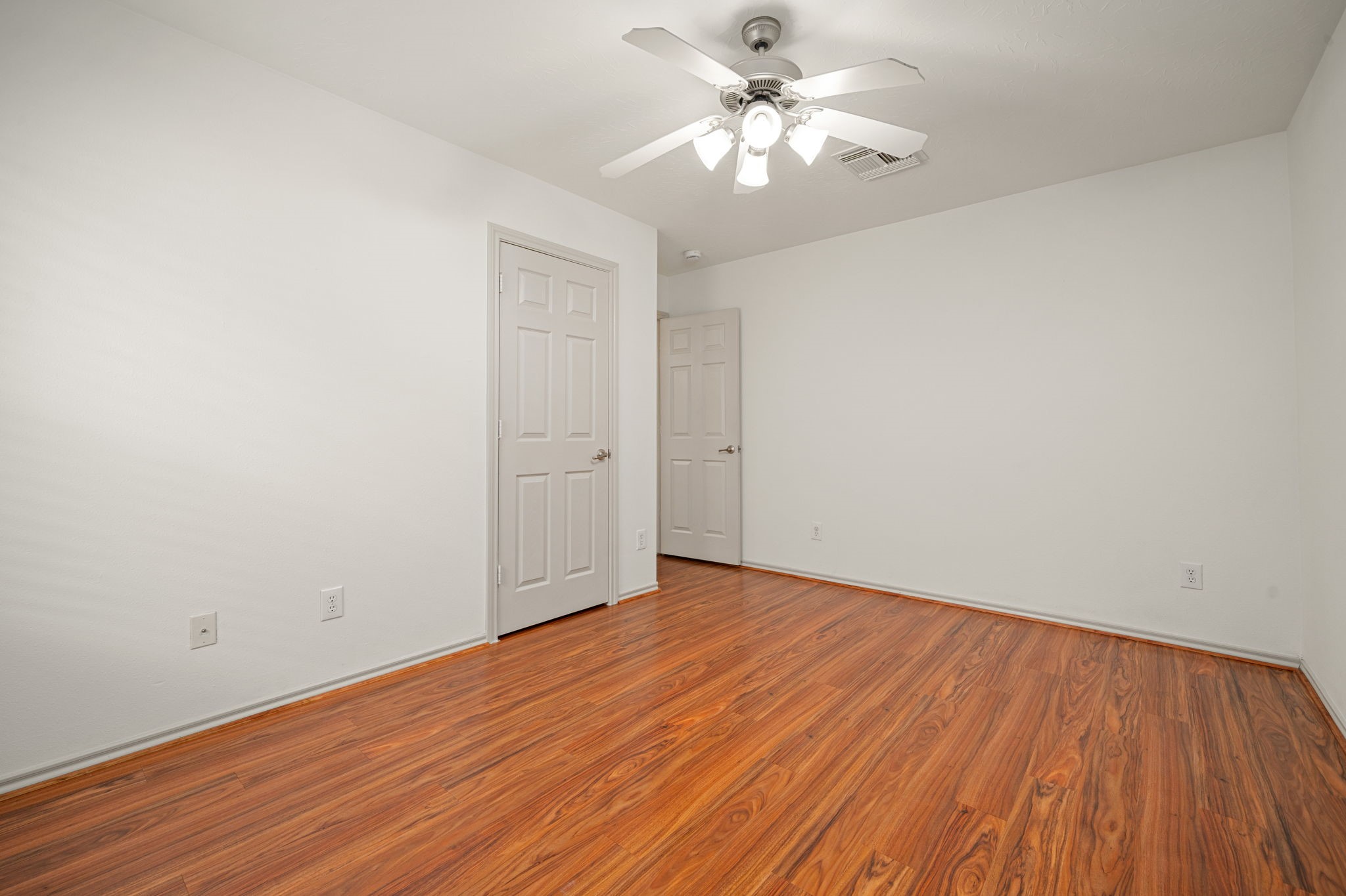 13410 Baron Hill Lane Rosharon, TX 77583 - Photo 29 of 40 an empty room with wooden floor and a ceiling fan