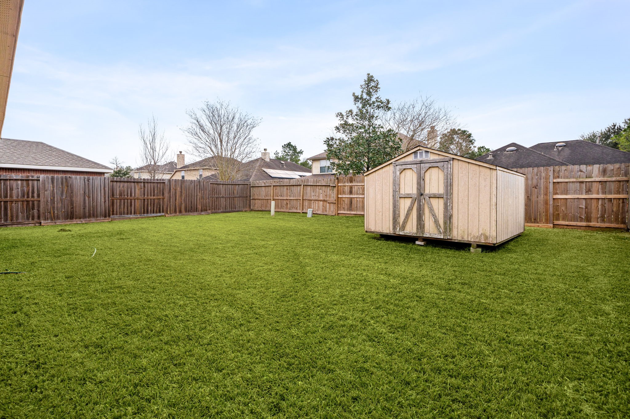 13410 Baron Hill Lane Rosharon, TX 77583 - Photo 34 of 40 a view of a backyard with potted plants and wooden fence