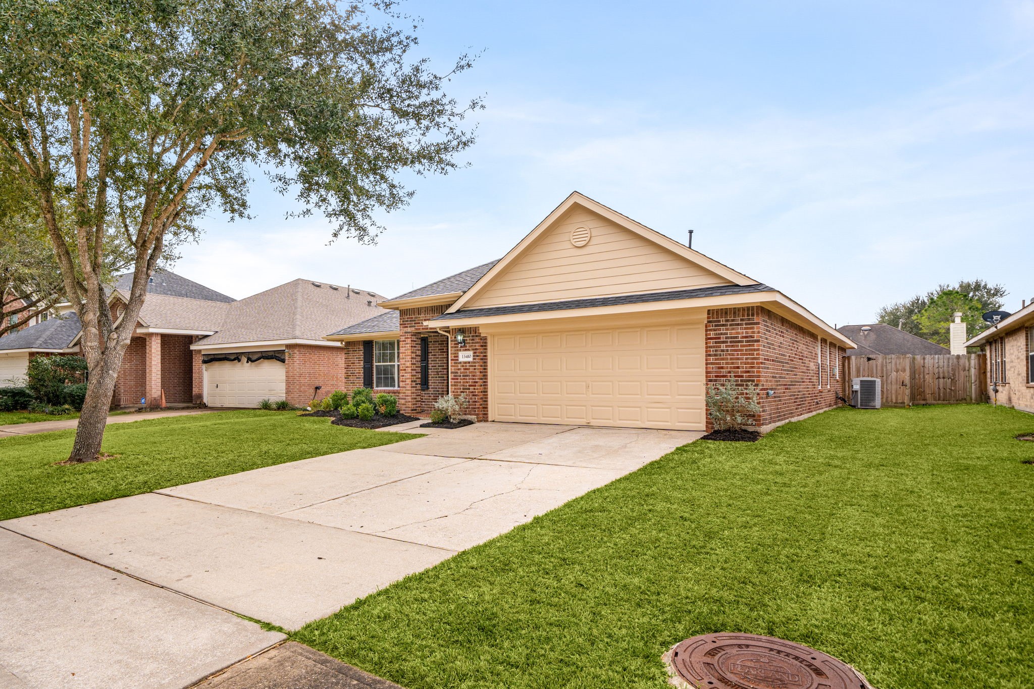 13410 Baron Hill Lane Rosharon, TX 77583 - Photo 5 of 40 a front view of a house with a yard and garage