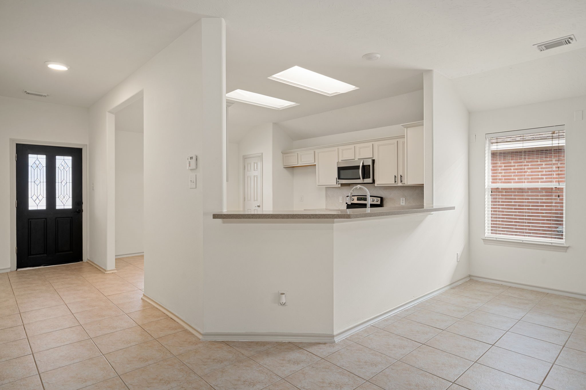 13410 Baron Hill Lane Rosharon, TX 77583 - Photo 7 of 40 a view of a kitchen with an empty space and a window