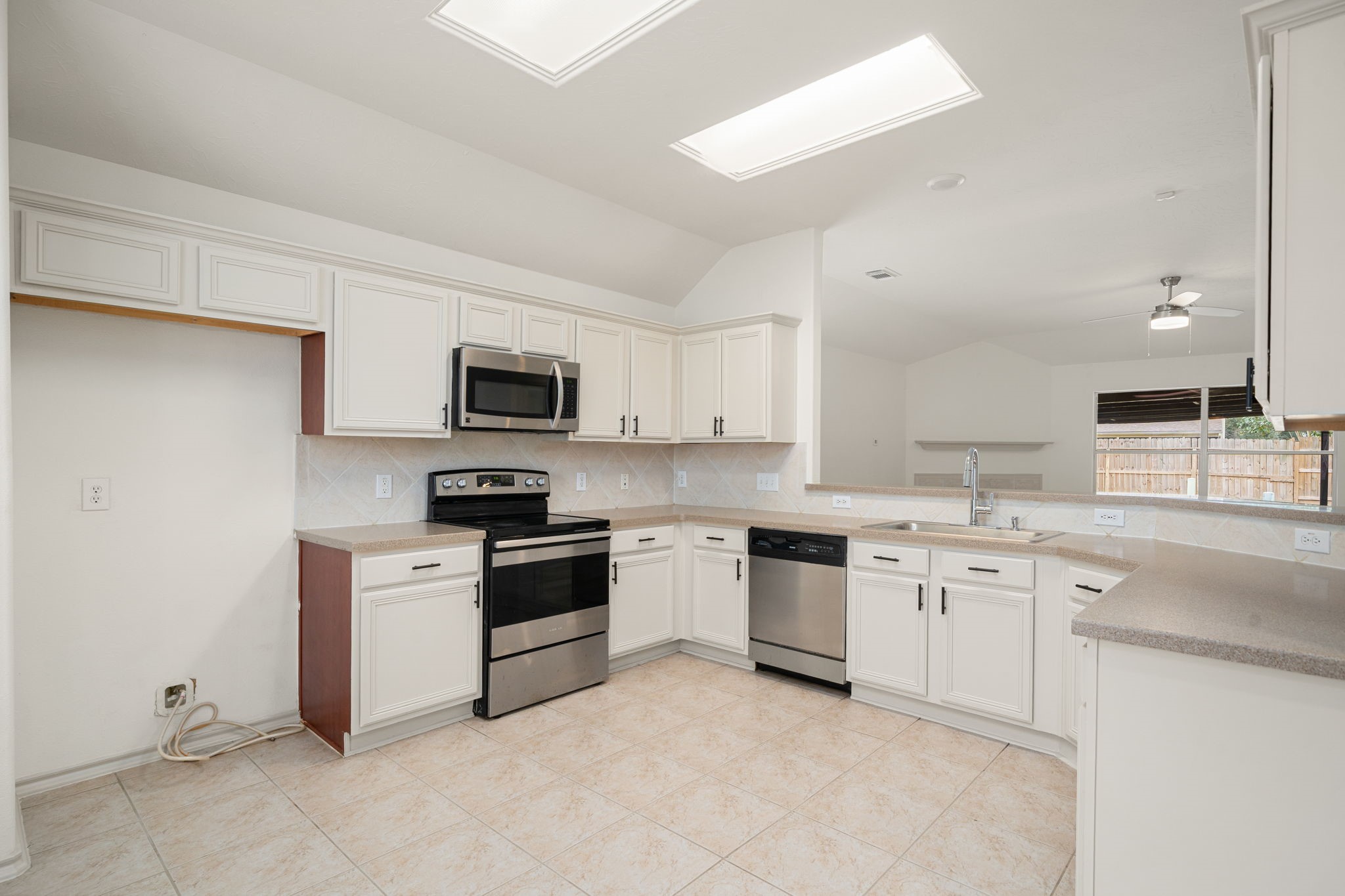 13410 Baron Hill Lane Rosharon, TX 77583 - Photo 9 of 40 a kitchen with a sink stove oven and white cabinets