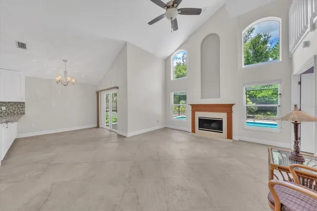 a view of an empty room and kitchen view