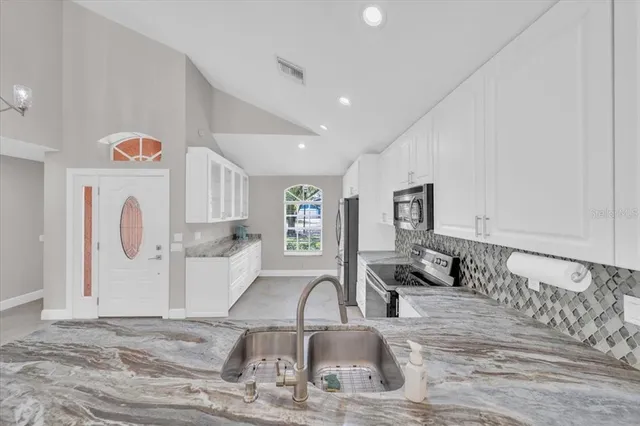 a very nice looking room with a large window and white walls