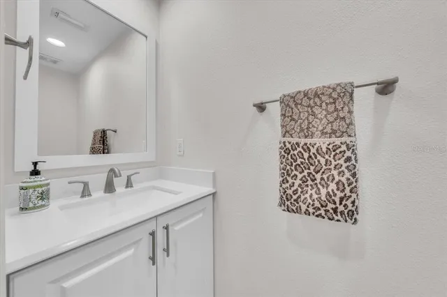 an empty room with wooden floor ceiling fan and windows