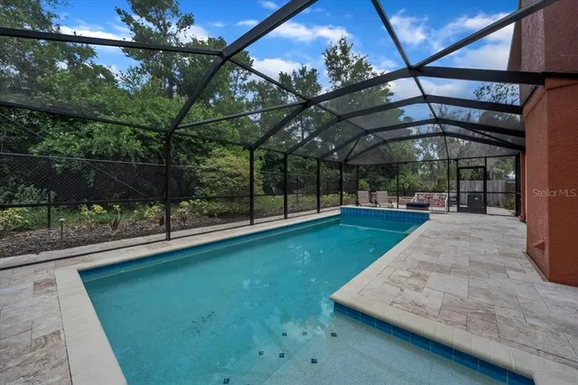 a view of a chair and table in the garden