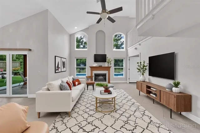 a view of a livingroom with a fireplace and window
