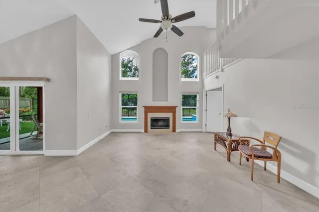 a living room with furniture a chandelier and a fireplace